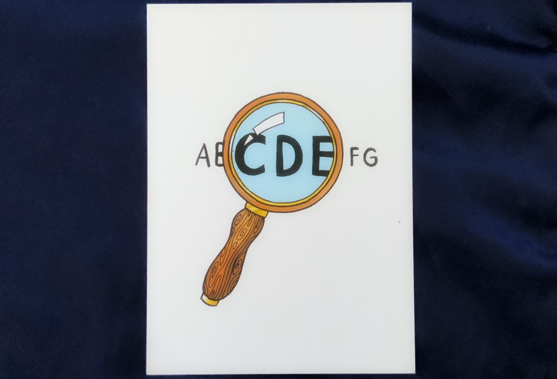 A hand-illustrated card showing a magnifying glass over a string of letters, magnifying the letters CDE